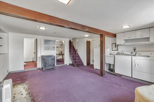 basement featuring dark colored carpet, independent washer and dryer, and sink