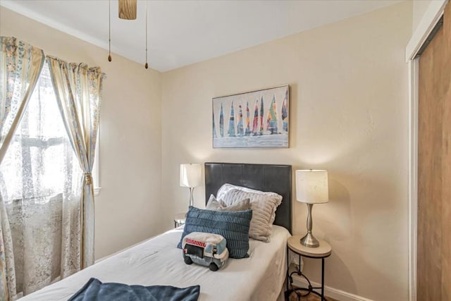 bedroom featuring ceiling fan and a closet