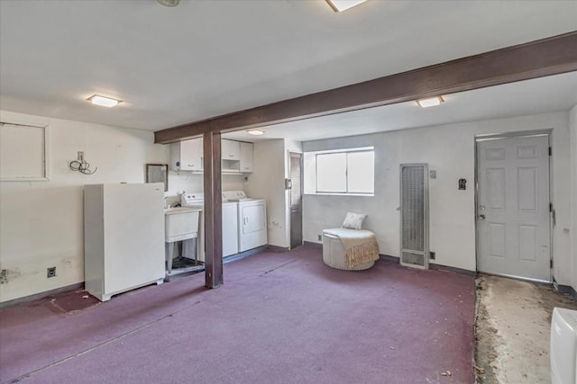 interior space featuring cabinets, washing machine and clothes dryer, and carpet floors