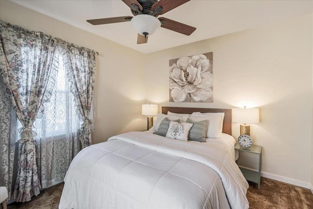 bedroom with ceiling fan and dark carpet