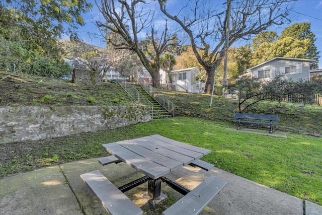 view of home's community with a lawn and a patio