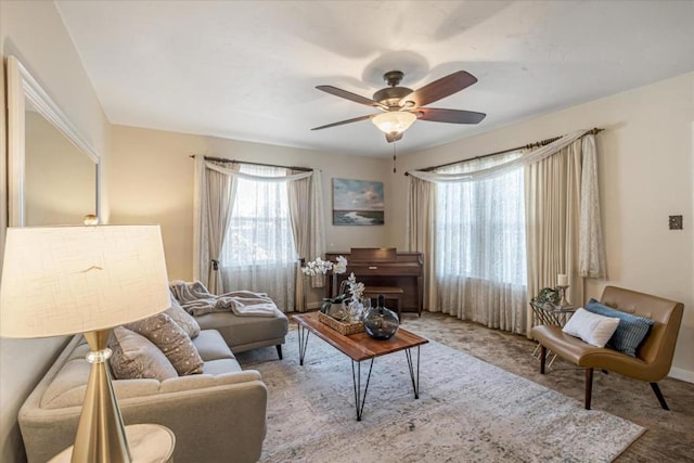 carpeted living room featuring ceiling fan