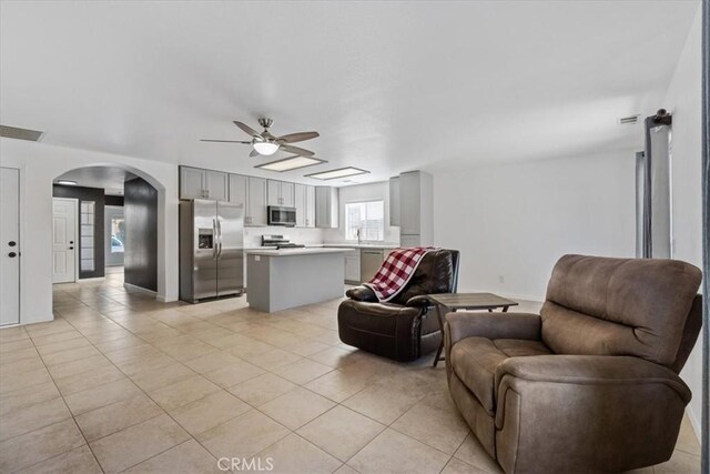 tiled living room with ceiling fan