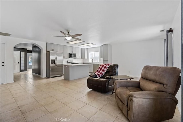 living room with ceiling fan and light tile patterned floors