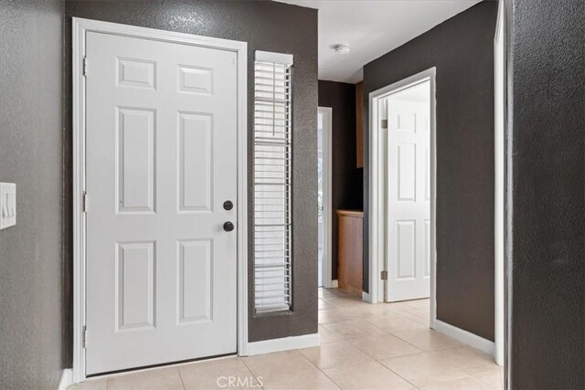 entryway with light tile patterned floors