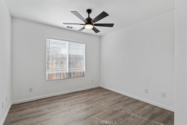 spare room with ceiling fan and light hardwood / wood-style floors