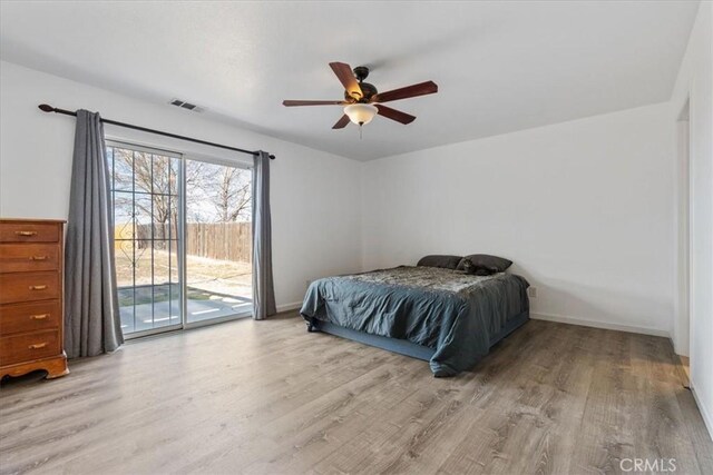 bedroom with access to outside, ceiling fan, and light wood-type flooring