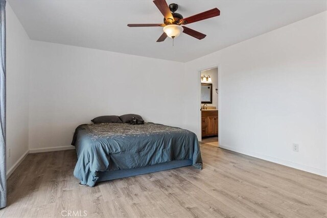 bedroom with ceiling fan, light hardwood / wood-style floors, and connected bathroom