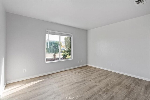 unfurnished room featuring light hardwood / wood-style flooring