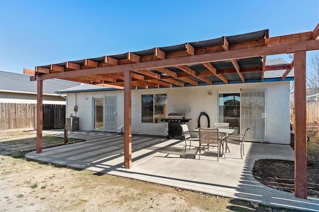 view of patio with area for grilling and a pergola