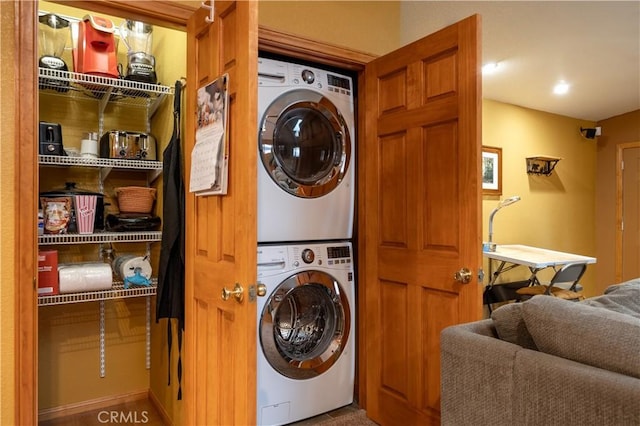 laundry room with stacked washer / drying machine