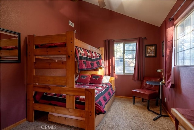 bedroom featuring light carpet and lofted ceiling