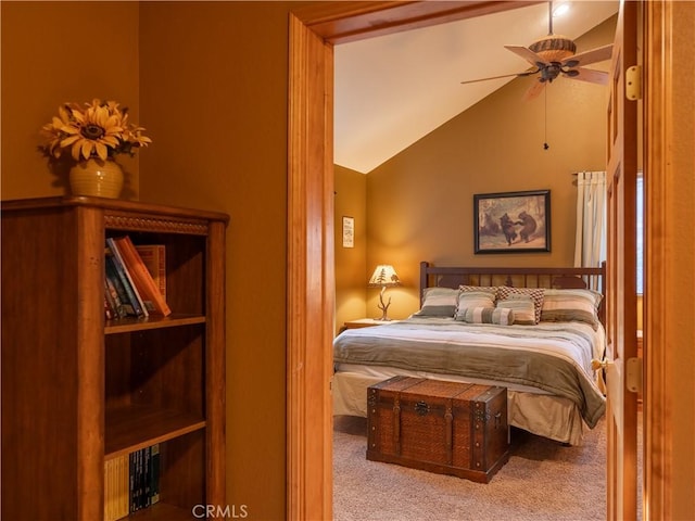 bedroom featuring ceiling fan, light colored carpet, and vaulted ceiling