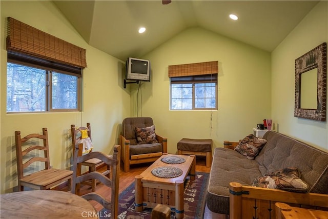 sitting room with plenty of natural light, wood-type flooring, and vaulted ceiling