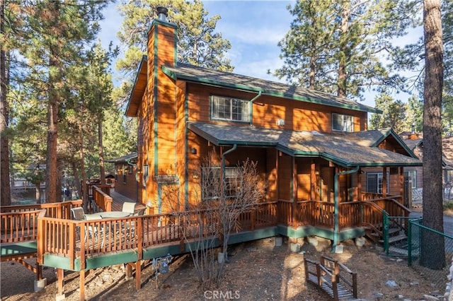 rear view of property featuring a deck