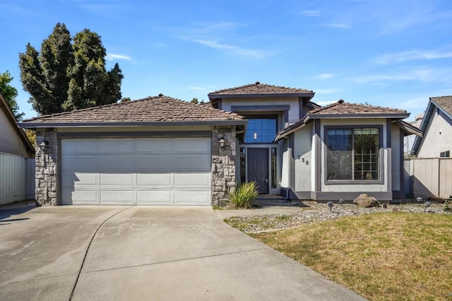 view of front of home with a front yard and a garage