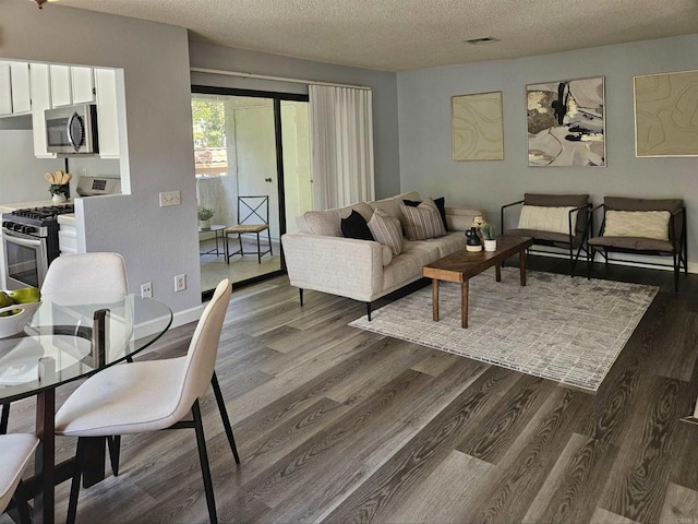 living room with hardwood / wood-style flooring and a textured ceiling