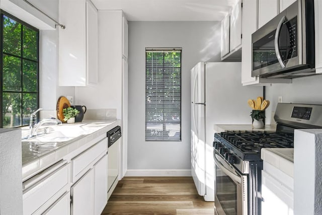 kitchen with stainless steel appliances and white cabinetry