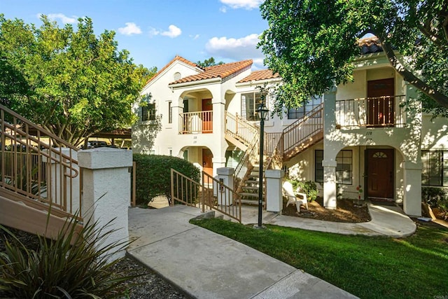 mediterranean / spanish house featuring a balcony