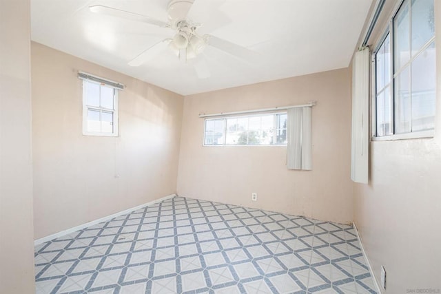 spare room with ceiling fan and a wealth of natural light