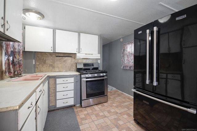 kitchen featuring gas stove, white cabinets, and high quality fridge