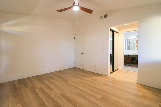 spare room featuring ceiling fan, light hardwood / wood-style flooring, and lofted ceiling