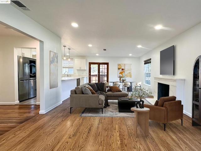 living room featuring light hardwood / wood-style floors and sink