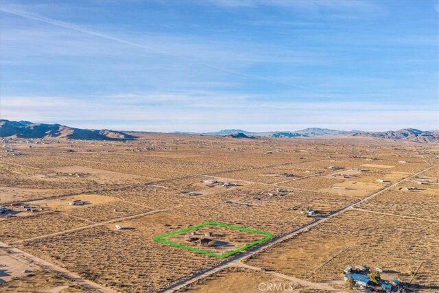 birds eye view of property featuring a mountain view