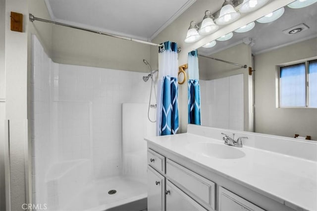 bathroom featuring ornamental molding, a shower stall, and vanity