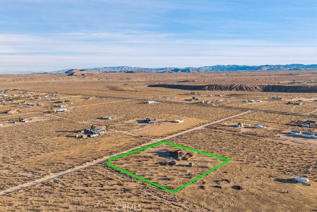 birds eye view of property with a mountain view and a rural view