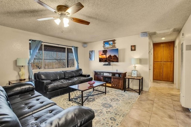 living area with light tile patterned floors, ceiling fan, and a textured ceiling