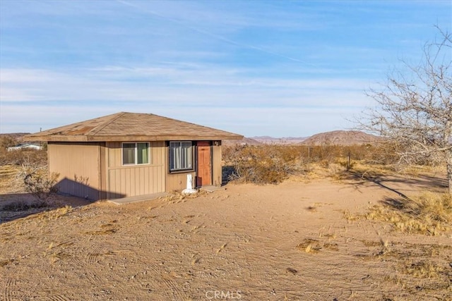 view of property exterior featuring an outbuilding and a mountain view