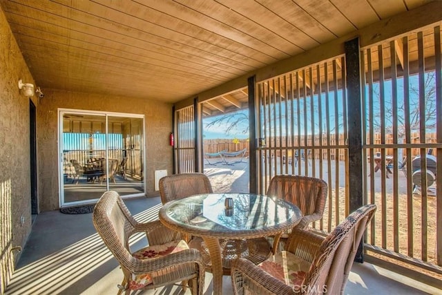 sunroom / solarium featuring wood ceiling