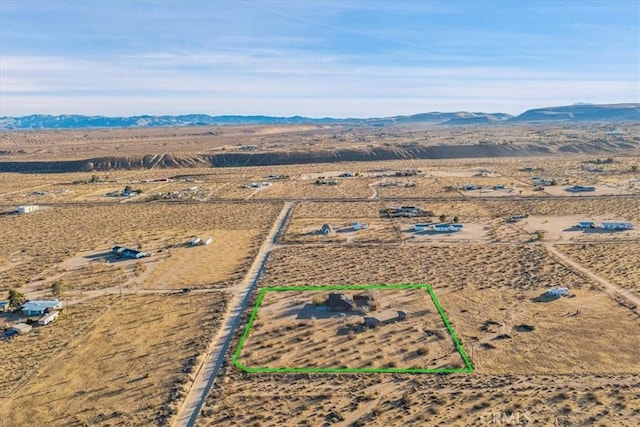 aerial view featuring a mountain view and view of desert