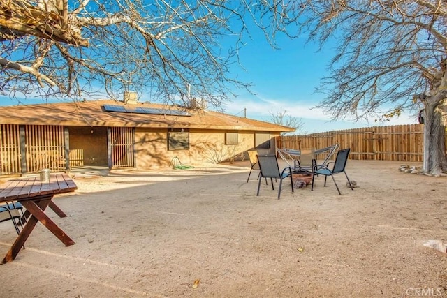 view of yard featuring an outdoor fire pit and fence