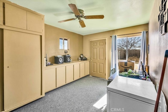 interior space featuring a ceiling fan and light colored carpet