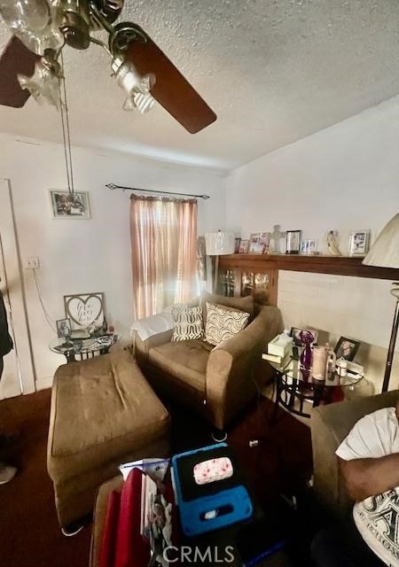 carpeted living room featuring a textured ceiling