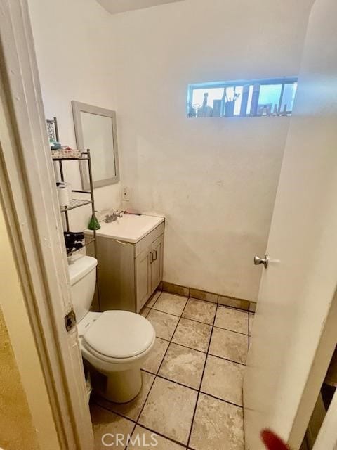 bathroom featuring toilet, vanity, and tile patterned flooring