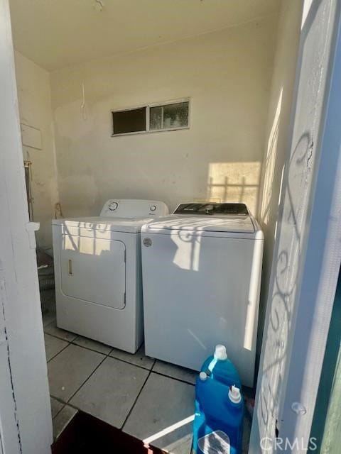 washroom featuring light tile patterned floors and separate washer and dryer