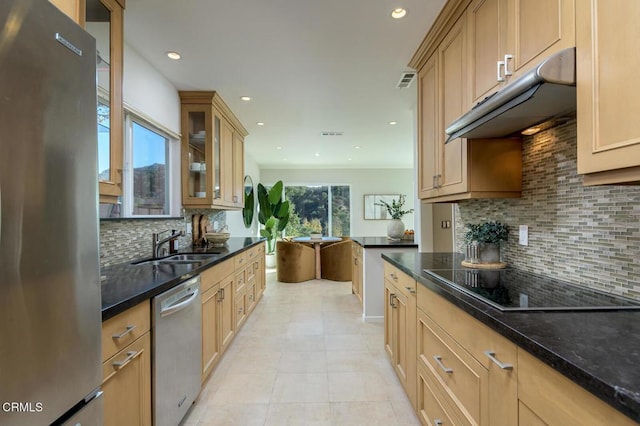 kitchen featuring light tile patterned floors, stainless steel appliances, decorative backsplash, and sink