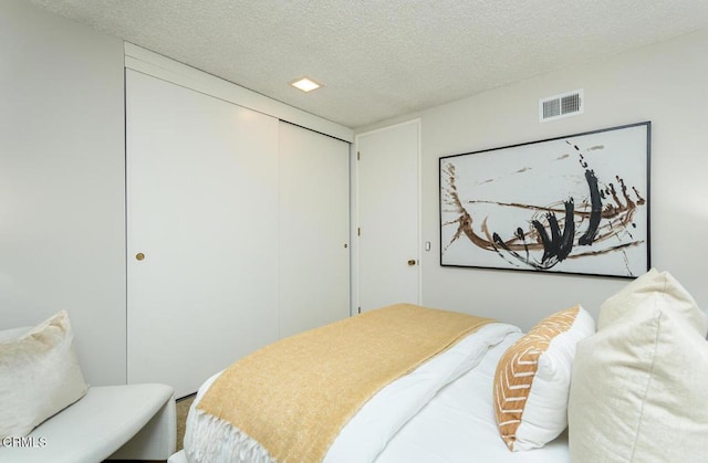 bedroom featuring a closet and a textured ceiling