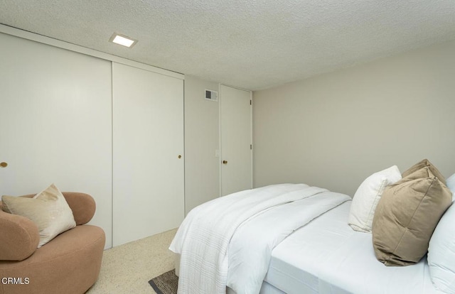 bedroom with a closet and a textured ceiling