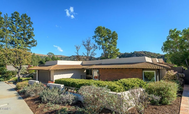 view of side of home with a mountain view