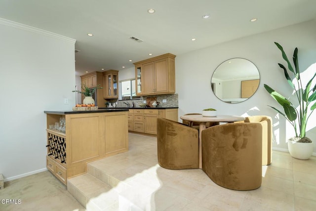 kitchen featuring light tile patterned floors, kitchen peninsula, light brown cabinets, tasteful backsplash, and sink