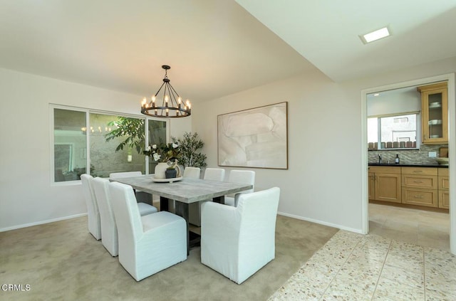 dining room featuring light colored carpet and an inviting chandelier