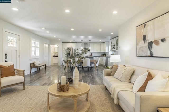 living room with hardwood / wood-style flooring and sink