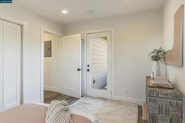 entryway with dark hardwood / wood-style floors and electric panel