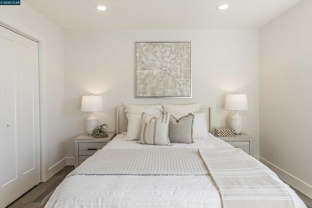 bedroom with a closet and dark hardwood / wood-style floors