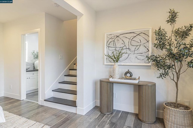 staircase with wood-type flooring