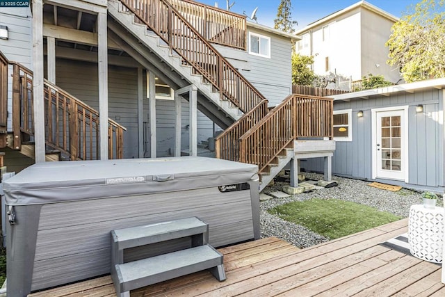 wooden deck featuring an outbuilding and a hot tub